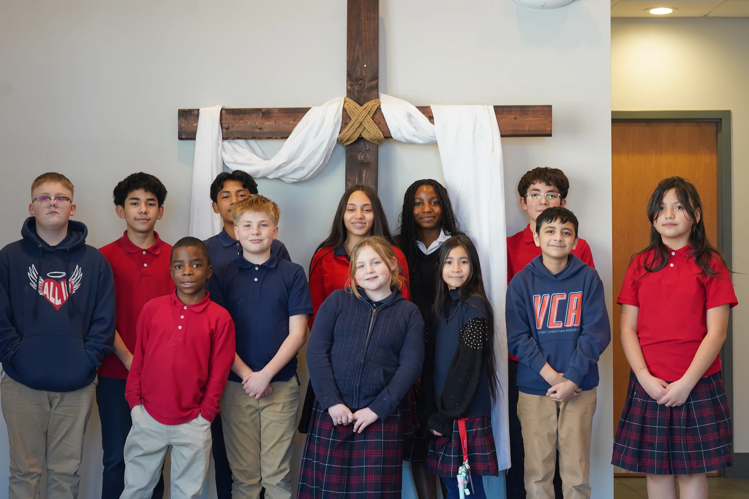 Victory Christian Academy students gathered in front of the chapel cross